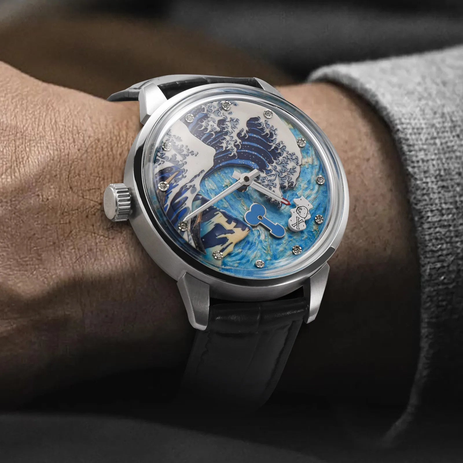 PINDU P6668 skeleton wave dial watch on wrist silver case black leather strap blue white wave art skeleton dial close-up wrist lifestyle shot